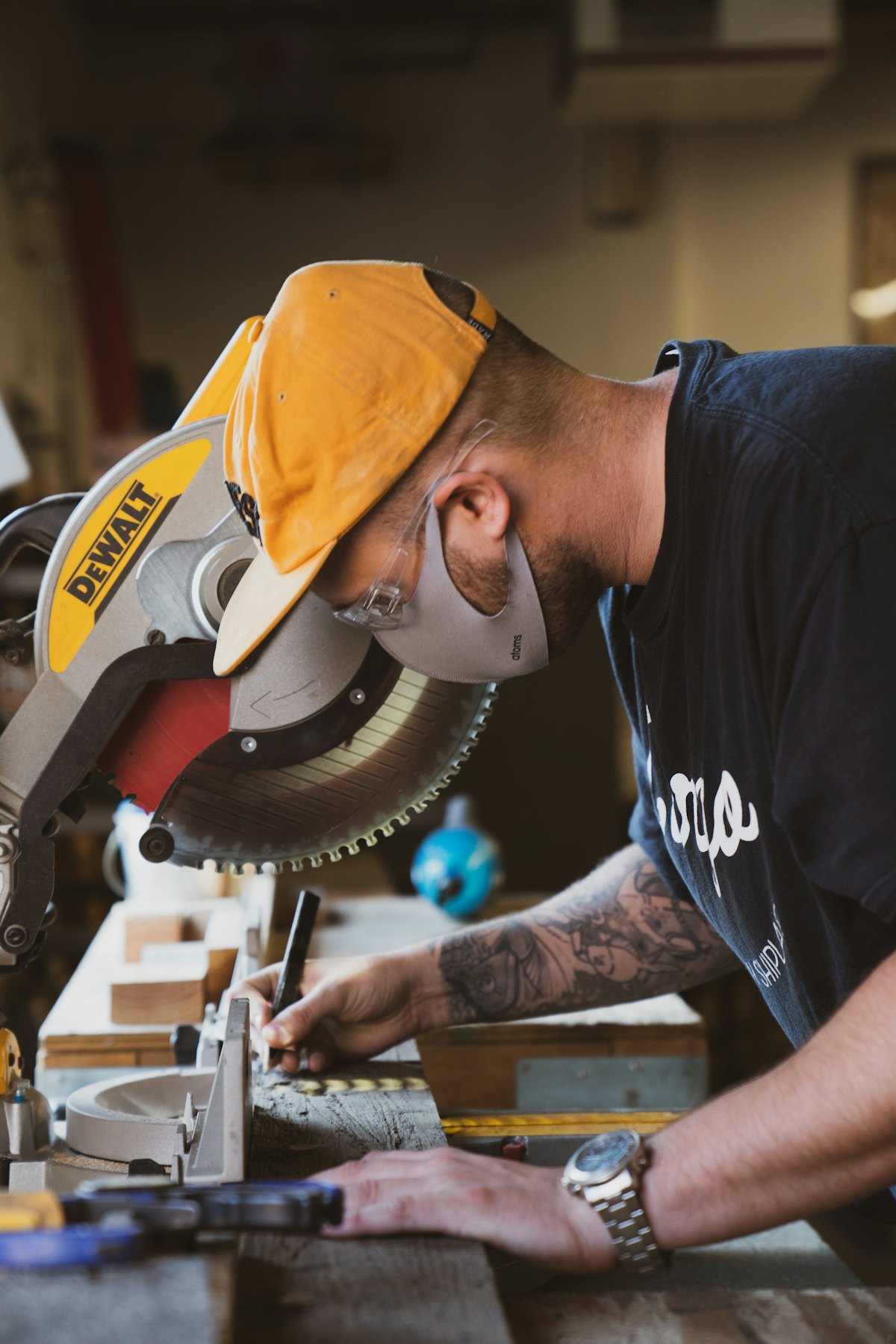 Joiner marking a cut at the mitre saw on site