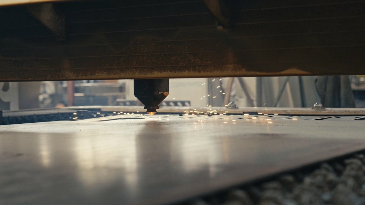 CNC plasma cutter head slicing sheet steel